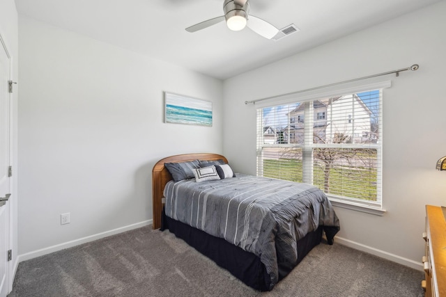 bedroom featuring multiple windows, baseboards, and carpet