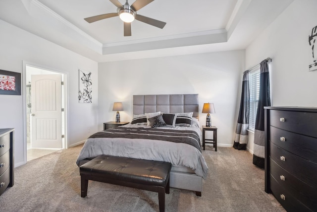 carpeted bedroom featuring baseboards, a raised ceiling, ceiling fan, and crown molding