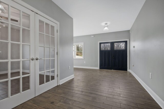 foyer entrance featuring dark wood-style floors, french doors, and baseboards