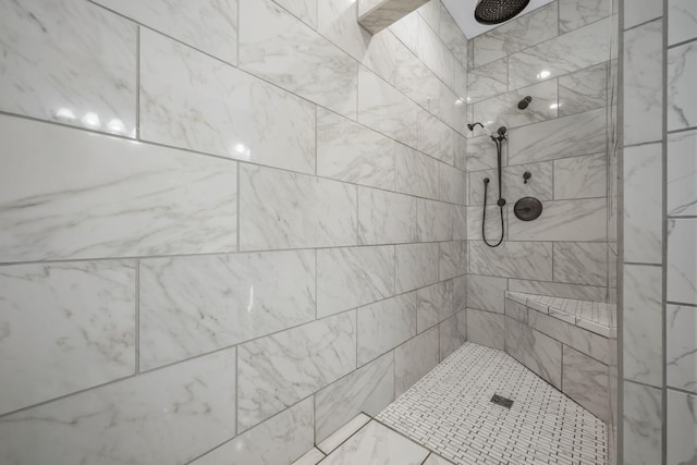 bathroom featuring a tile shower