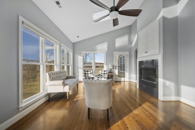 living area with ceiling fan, visible vents, baseboards, and dark wood-style floors