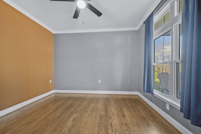 unfurnished room featuring ceiling fan, baseboards, wood finished floors, and ornamental molding