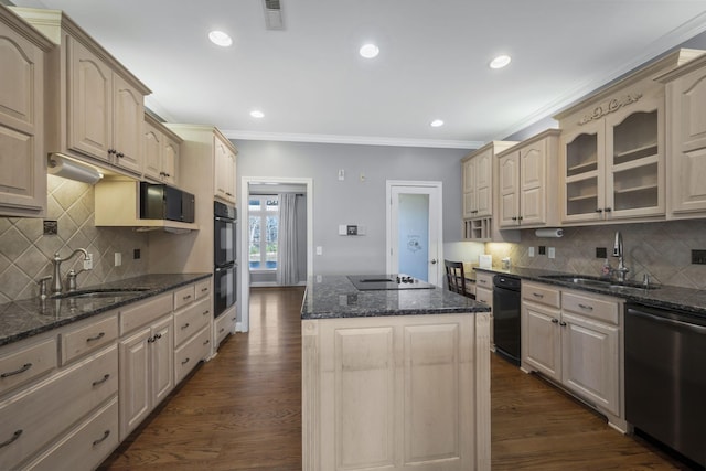 kitchen with a center island, visible vents, black appliances, and a sink