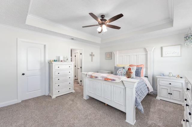 bedroom with a textured ceiling, a raised ceiling, crown molding, and light carpet