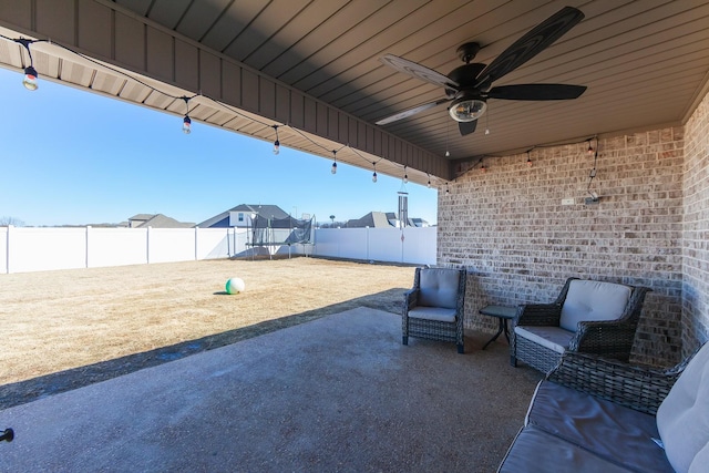 view of patio with a fenced backyard and ceiling fan