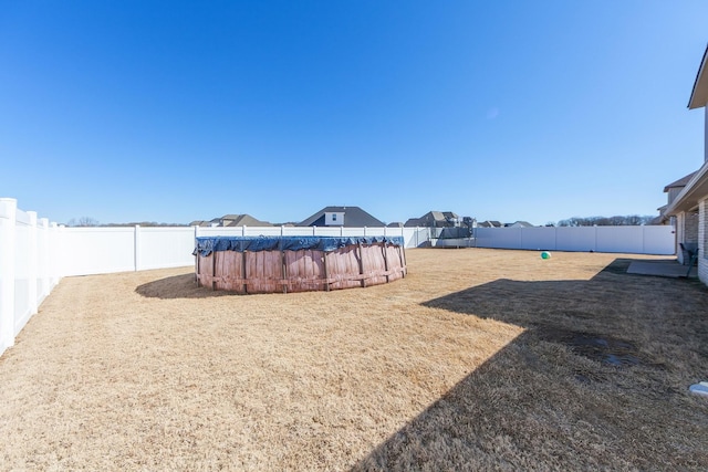 view of yard with a fenced in pool and a fenced backyard