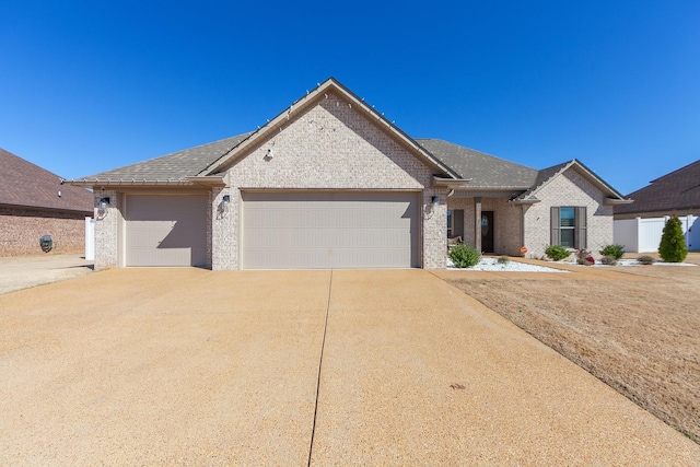 view of front of house with brick siding, an attached garage, concrete driveway, and roof with shingles