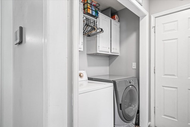 clothes washing area with cabinet space and washing machine and clothes dryer