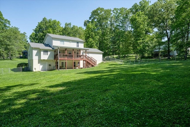 rear view of property with a fenced backyard, a wooden deck, stairs, and a yard