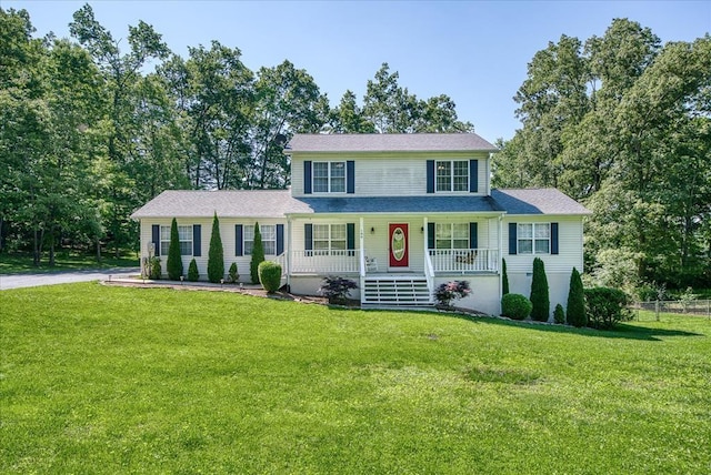 view of front of house with a porch, a front yard, and aphalt driveway