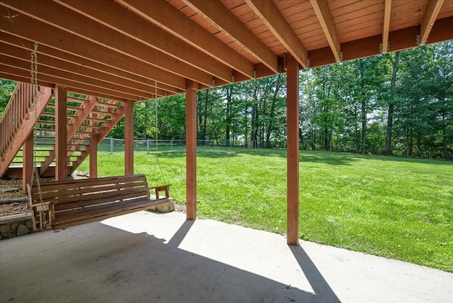 view of patio / terrace featuring stairway and fence