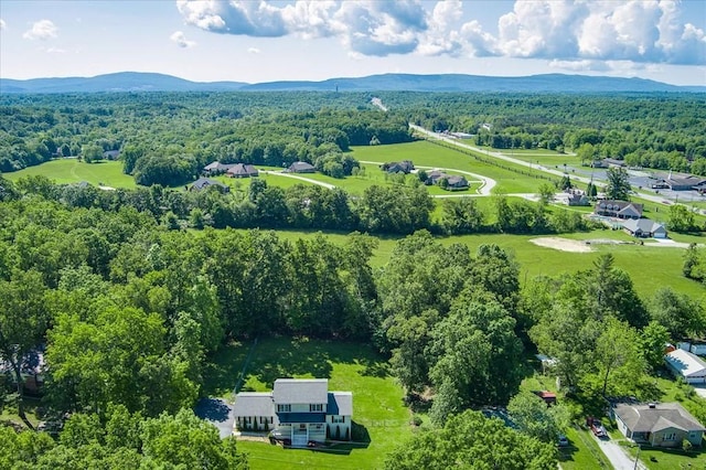 drone / aerial view with a mountain view and a wooded view