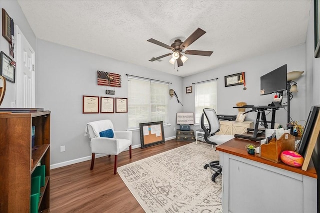 office with baseboards, wood finished floors, a textured ceiling, and ceiling fan