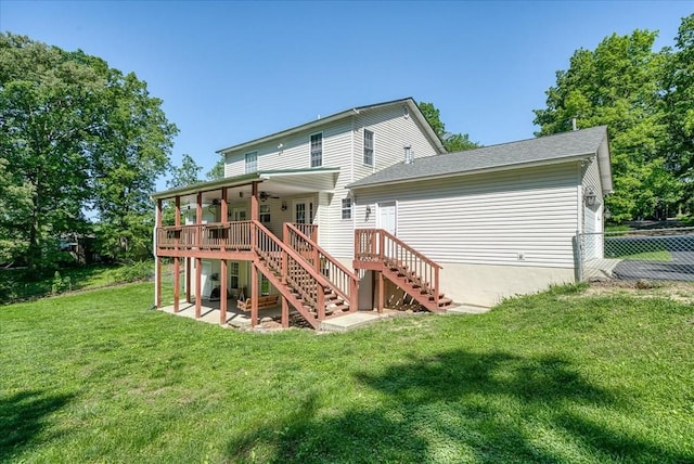 back of property featuring stairway, fence, a wooden deck, a yard, and ceiling fan