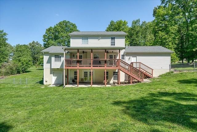 rear view of house with ceiling fan, fence, a lawn, a patio area, and an attached garage