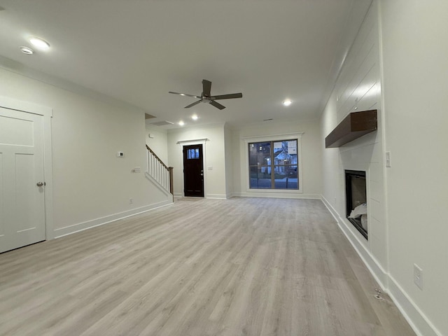 7132 Silverwood Trl, Hermitage, TN 37076 - unfurnished living room with baseboards, ceiling fan, light wood-type flooring, stairs, and a fireplace