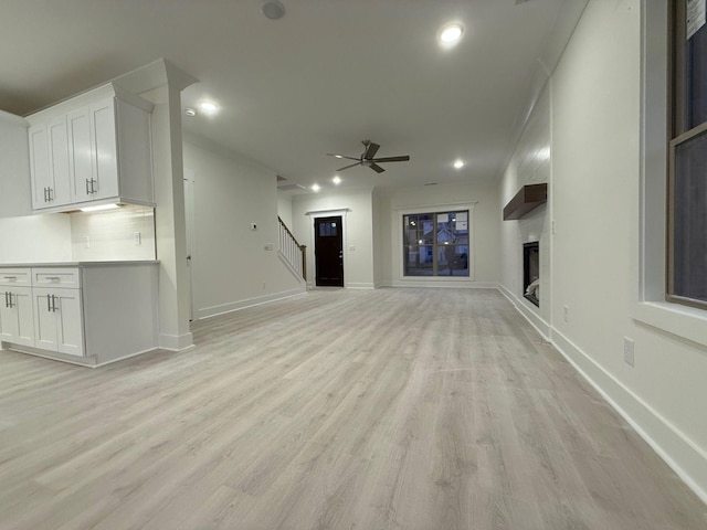 7132 Silverwood Trl, Hermitage, TN 37076 - unfurnished living room with recessed lighting, stairway, light wood-style floors, and ceiling fan