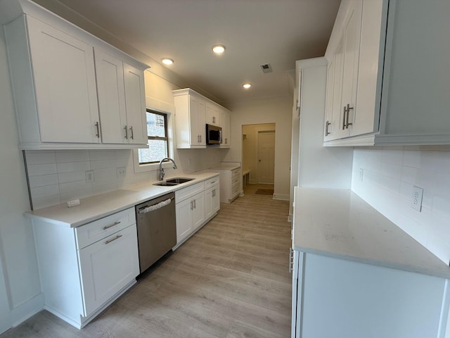 7132 Silverwood Trl, Hermitage, TN 37076 - kitchen featuring visible vents, a sink, stainless steel appliances, white cabinets, and light wood-style floors
