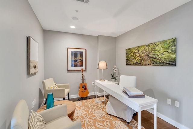 office space featuring recessed lighting, visible vents, baseboards, and wood finished floors