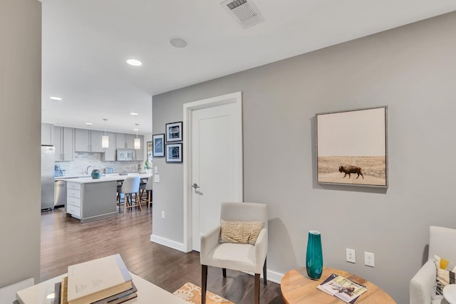 interior space featuring dark wood finished floors, recessed lighting, visible vents, and baseboards