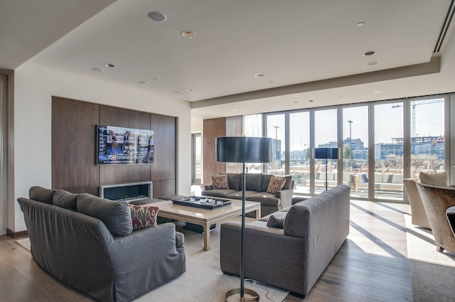 living area with recessed lighting, wood finished floors, and a fireplace