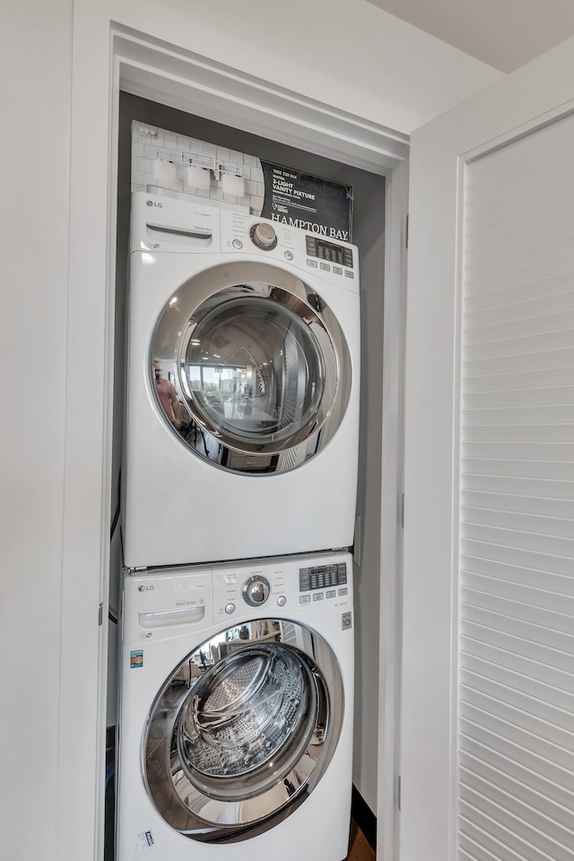 laundry area featuring stacked washer and dryer and laundry area