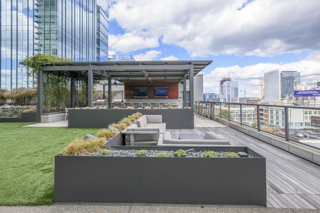 wooden terrace with an outdoor living space, a view of city, and a lawn