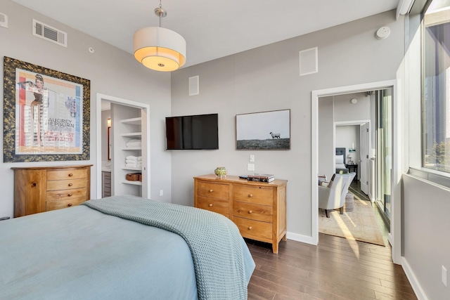 bedroom featuring dark wood-type flooring, baseboards, and visible vents