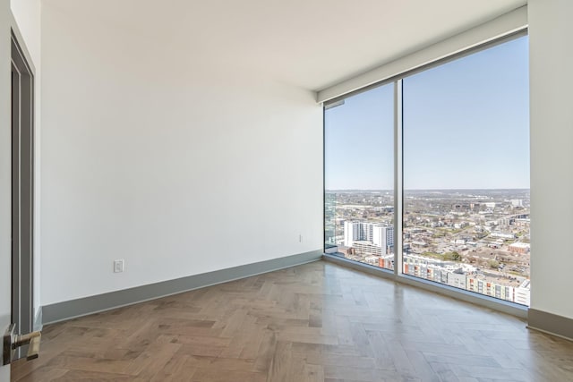1616 W End Ave Unit 2602, Nashville, TN 37203 - empty room with a view of city, baseboards, and expansive windows