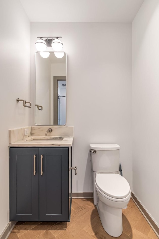 1616 W End Ave Unit 2602, Nashville, TN 37203 - bathroom featuring baseboards, toilet, and vanity
