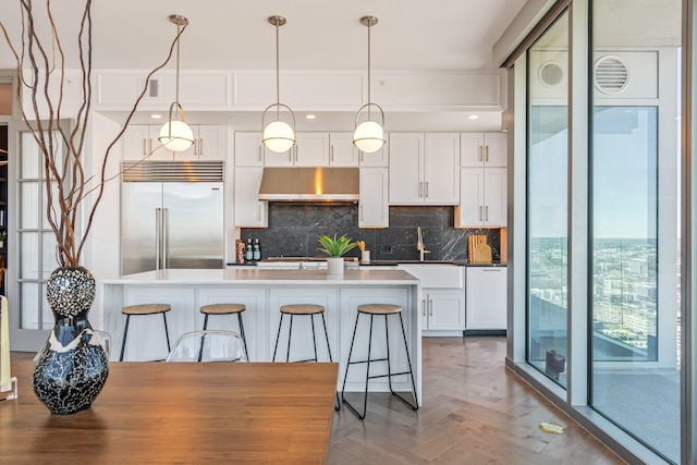 1616 W End Ave Unit 2602, Nashville, TN 37203 - kitchen featuring tasteful backsplash, under cabinet range hood, white dishwasher, white cabinets, and a sink