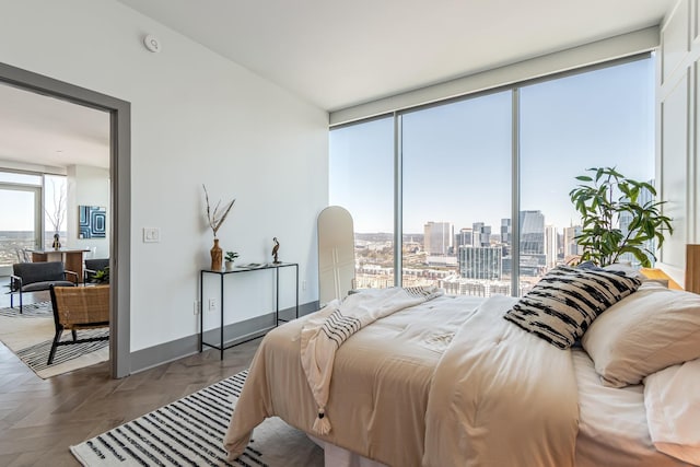 1616 W End Ave Unit 2602, Nashville, TN 37203 - bedroom featuring a wall of windows, a view of city, and baseboards