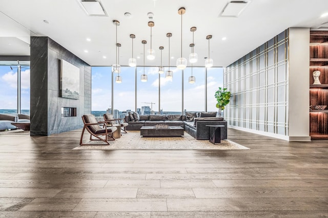 1616 W End Ave Unit 2602, Nashville, TN 37203 - living room featuring expansive windows, a healthy amount of sunlight, and wood finished floors