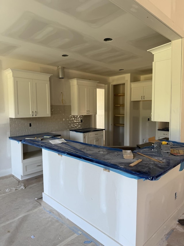 1513 Garners Creek Rd, Dickson, TN 37055 - kitchen with backsplash, dark countertops, and white cabinetry