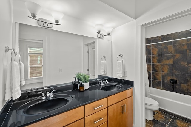 bathroom featuring shower / tub combo with curtain, double vanity, a sink, and toilet