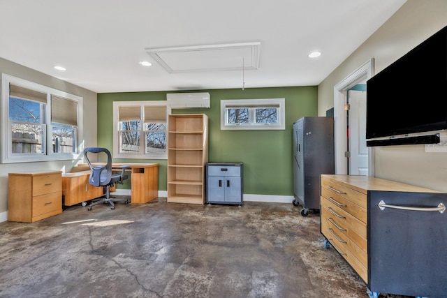 office space with attic access, a healthy amount of sunlight, concrete floors, and a wall mounted air conditioner
