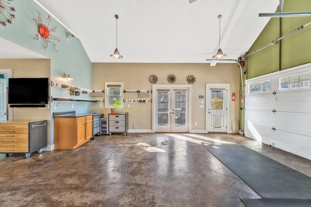 garage featuring french doors and baseboards