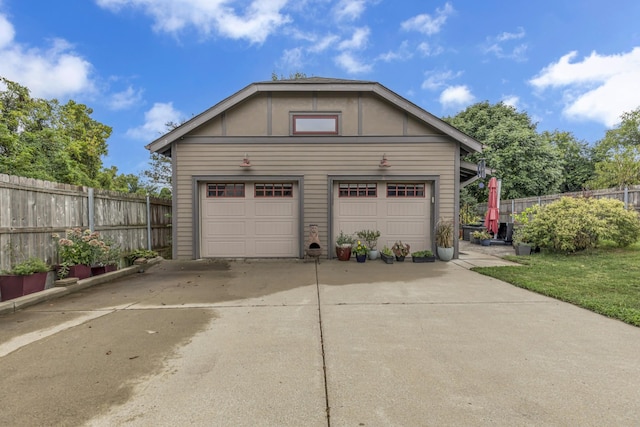 detached garage featuring fence