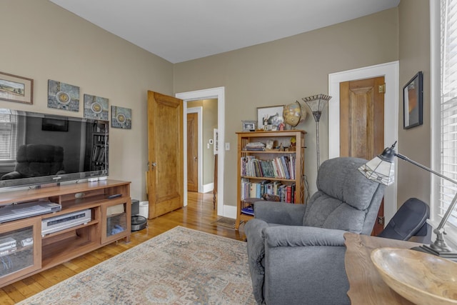 living area featuring wood finished floors and baseboards