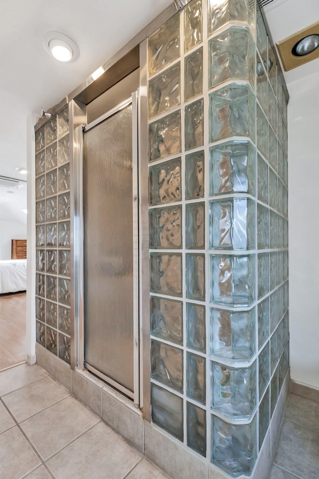 full bath with tile patterned floors, a stall shower, and ensuite bath