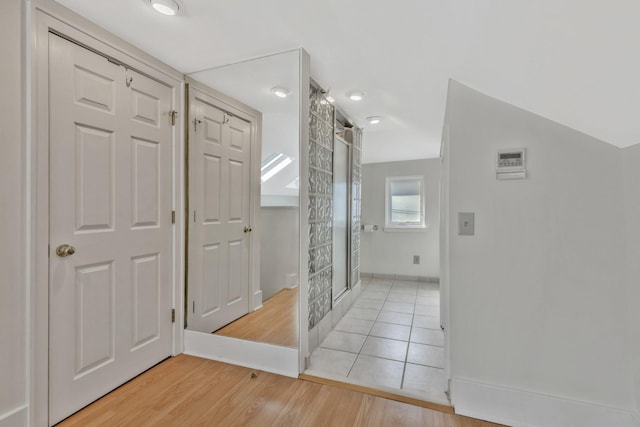foyer entrance featuring light wood-type flooring and baseboards