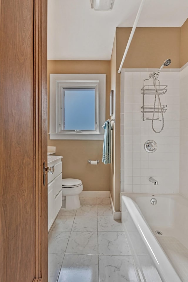 bathroom featuring toilet, marble finish floor, tub / shower combination, baseboards, and vanity