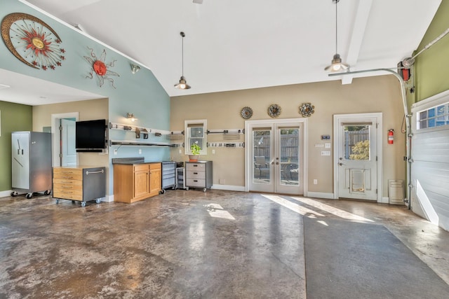 kitchen featuring finished concrete floors, french doors, pendant lighting, and baseboards