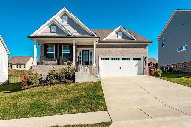 view of front of house featuring driveway, a porch, an attached garage, a front yard, and brick siding
