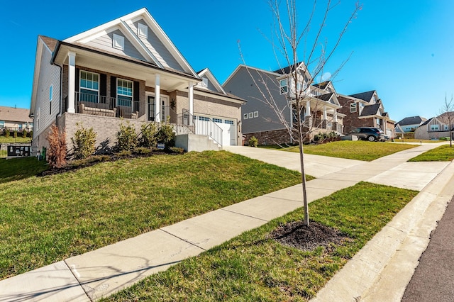 view of front of property with a front lawn, driveway, a residential view, covered porch, and a garage