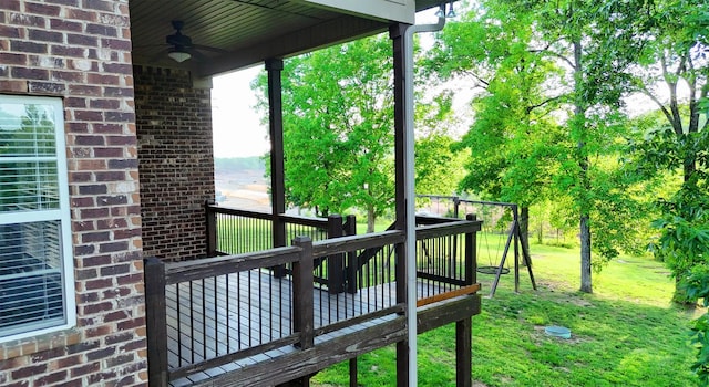 wooden terrace with a yard and a ceiling fan