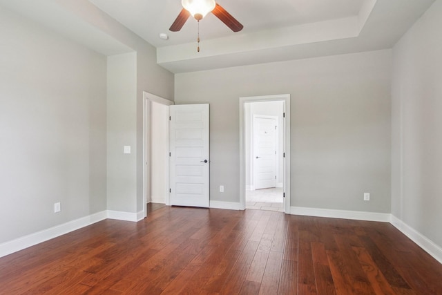 unfurnished bedroom with dark wood-style flooring, baseboards, and ceiling fan