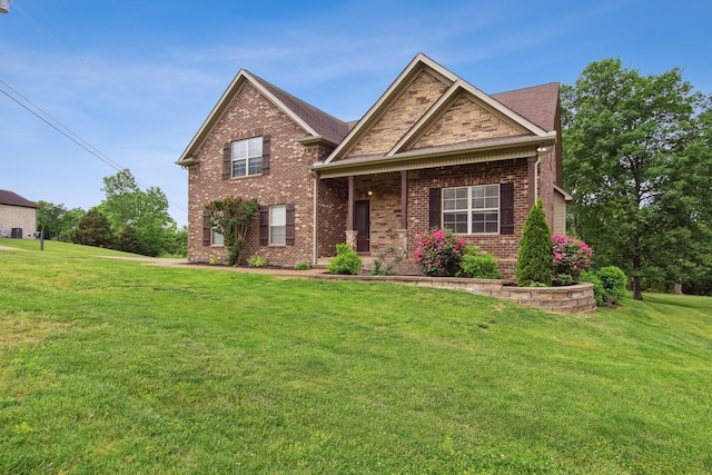 view of front of house with a front yard and brick siding