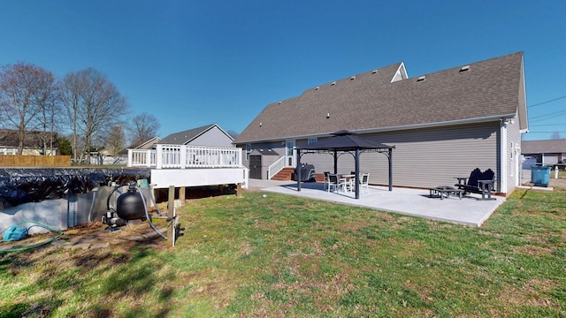 back of property featuring a patio, fence, a gazebo, a deck, and a lawn