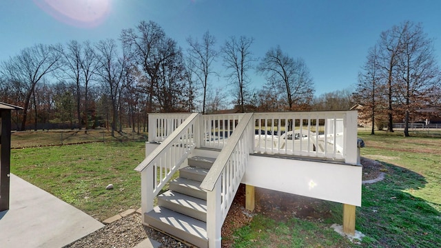 wooden terrace with a lawn and stairs